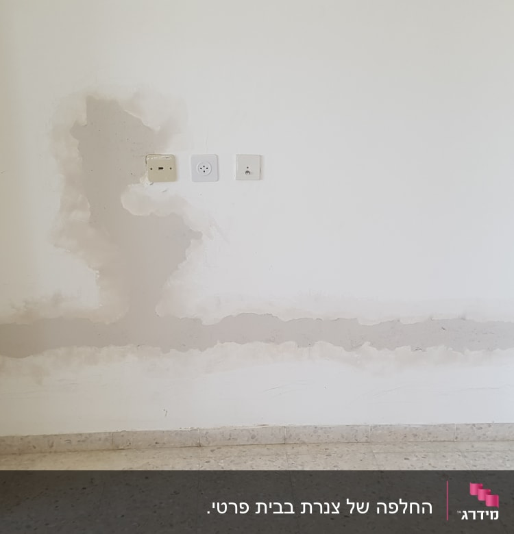 קיר עם סימני תיקון ושקעי חשמל